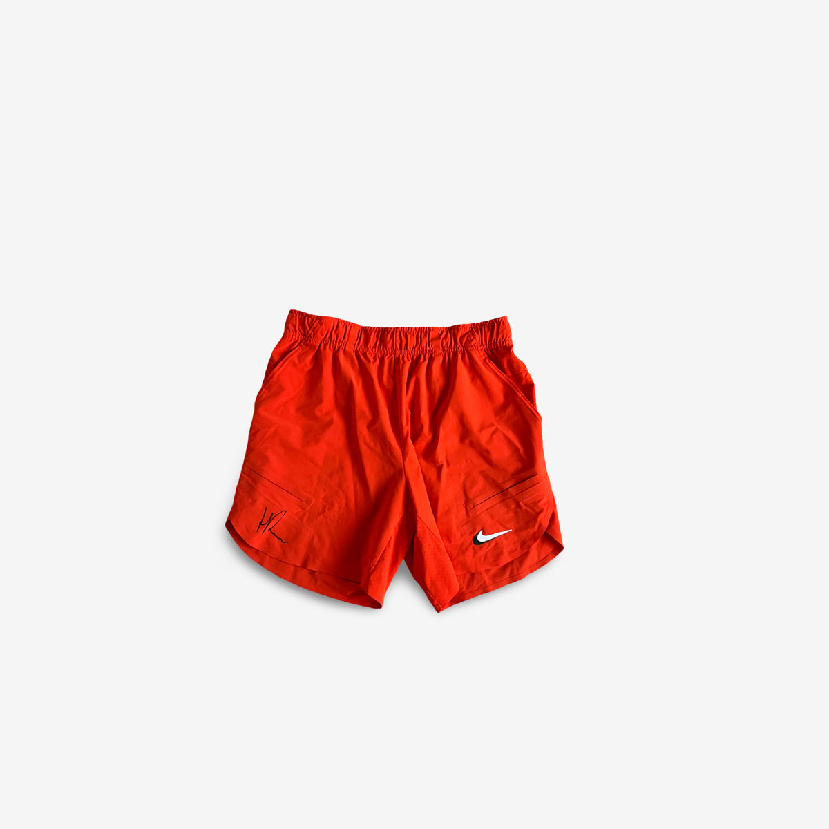 Orange practice and match shorts , signed